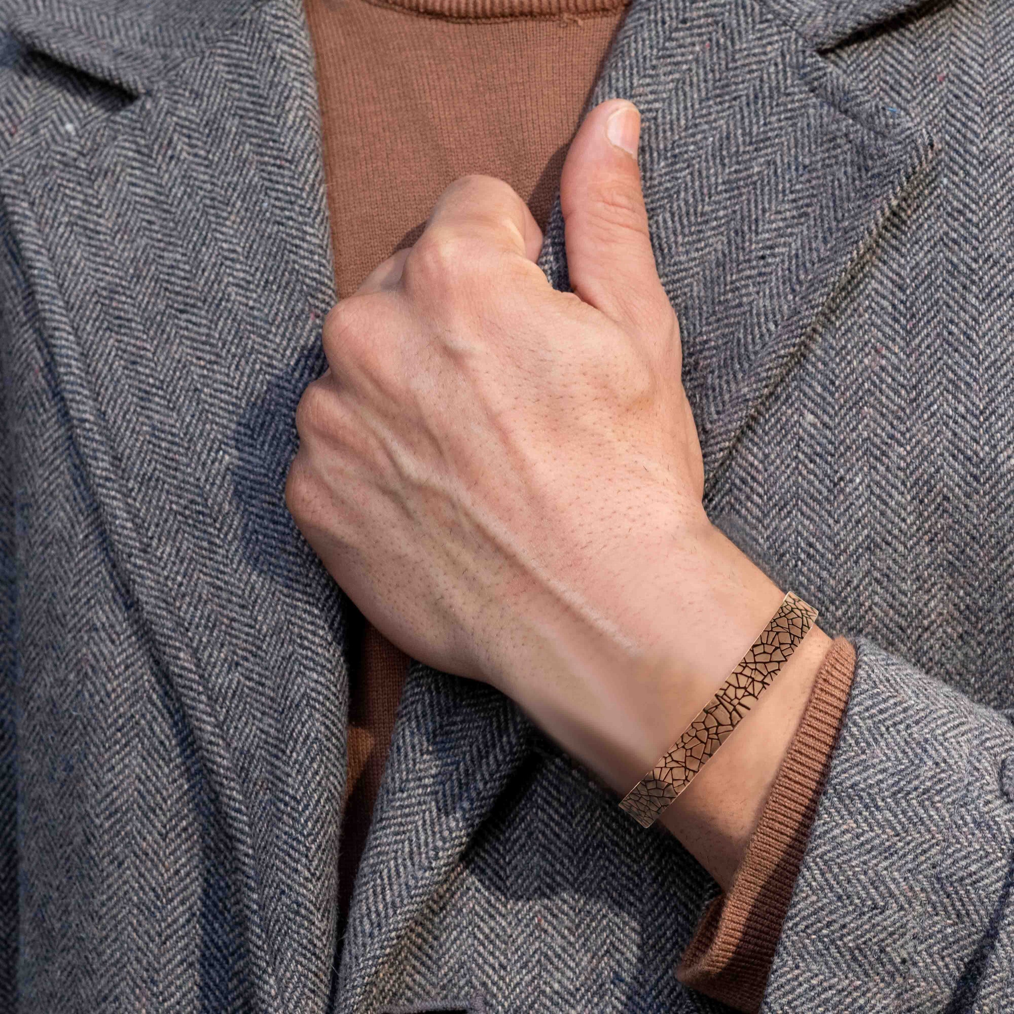 10mm Wide Men's Embossed Mosaic Solid Copper Cuff on Male Model's Wrist Wearing Gray Sportscoat