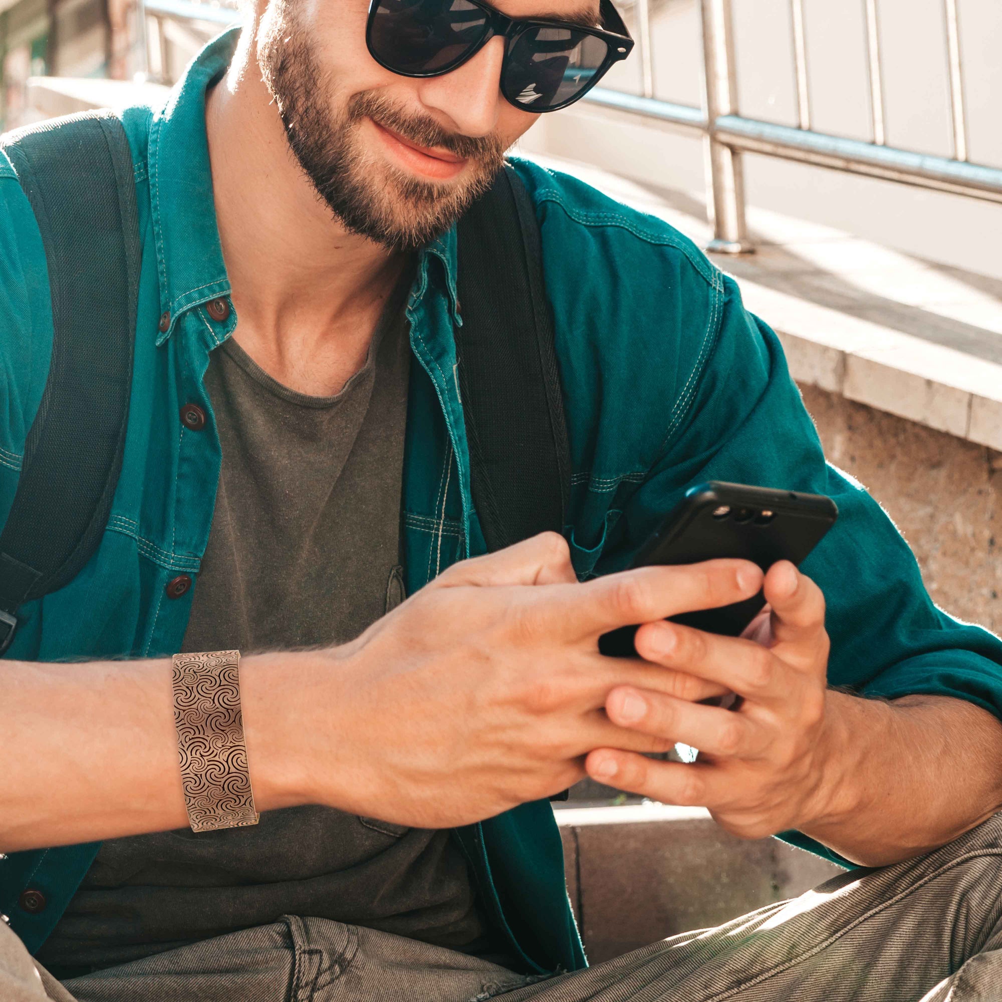 Man in Green Shirt Wearing  Solid Copper 1 Inch Wide Wave Embossed Cuff on Wrist