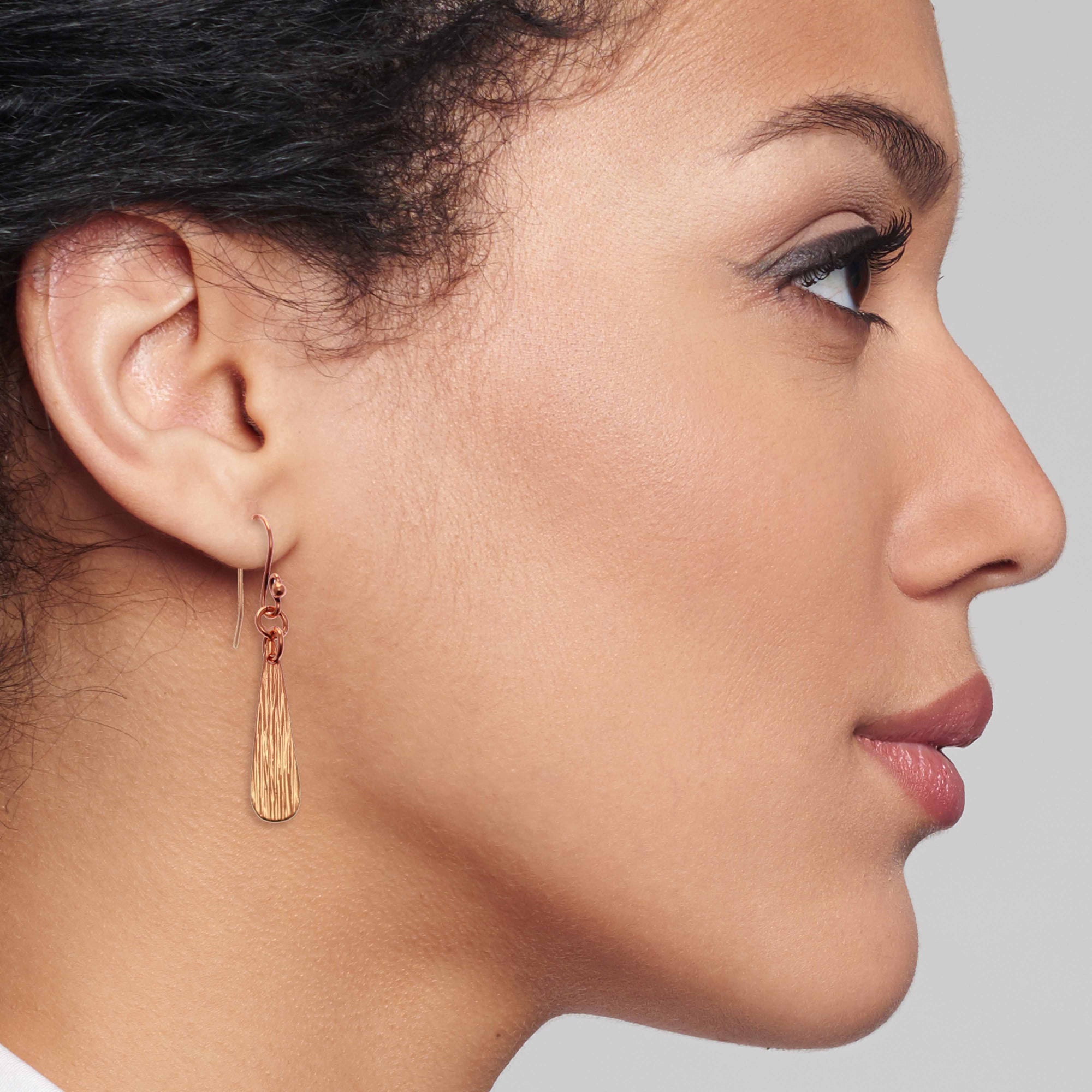 Elegant Woman Wearing Bark Embossed Mini Copper Teardrop Earrings