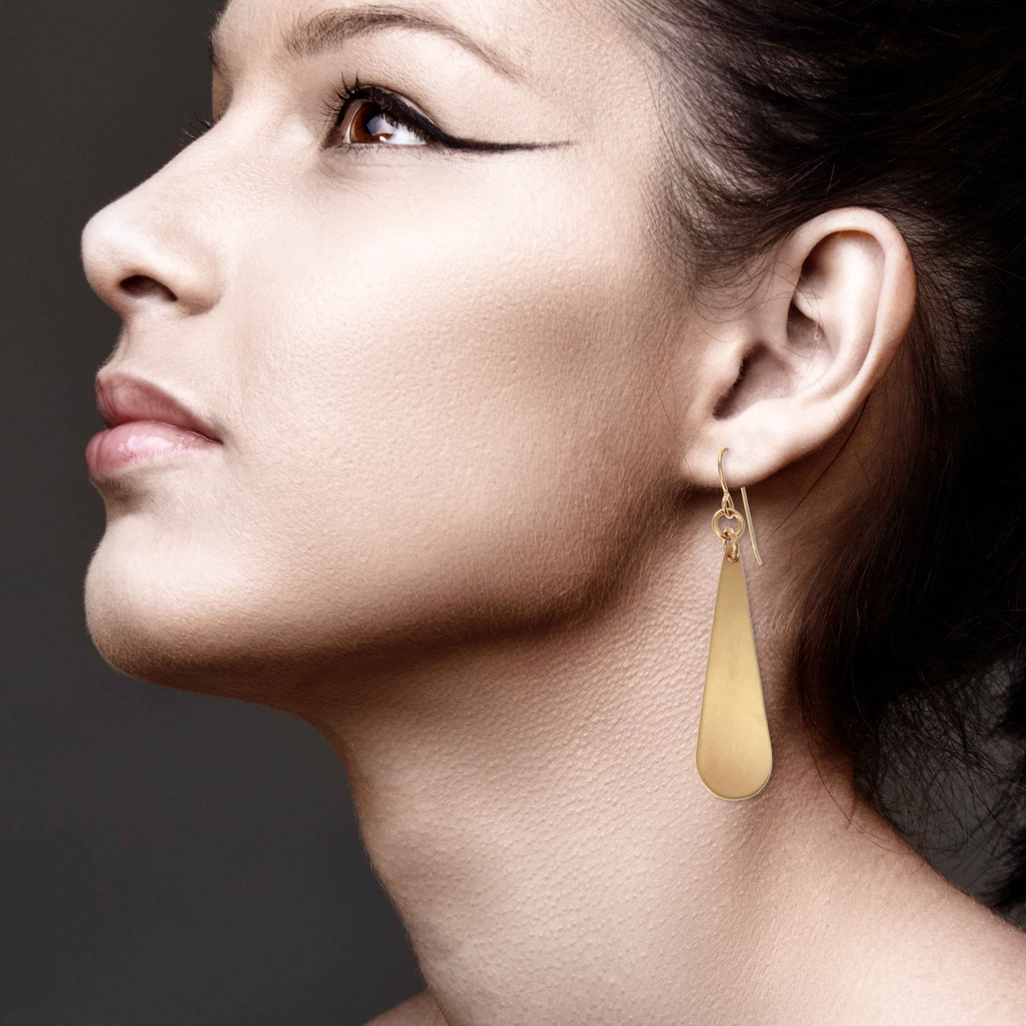 Stunning Woman Wearing Brushed Bronze Long Teardrop Earrings