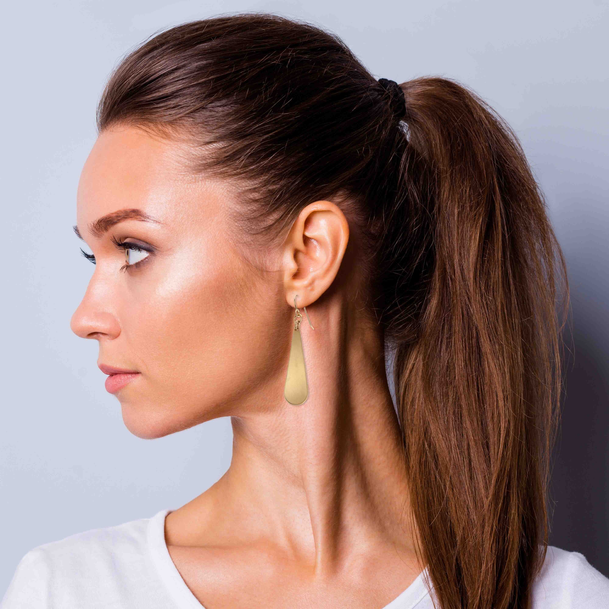 Woman In White T Wearing Brushed Bronze Long Teardrop Earrings