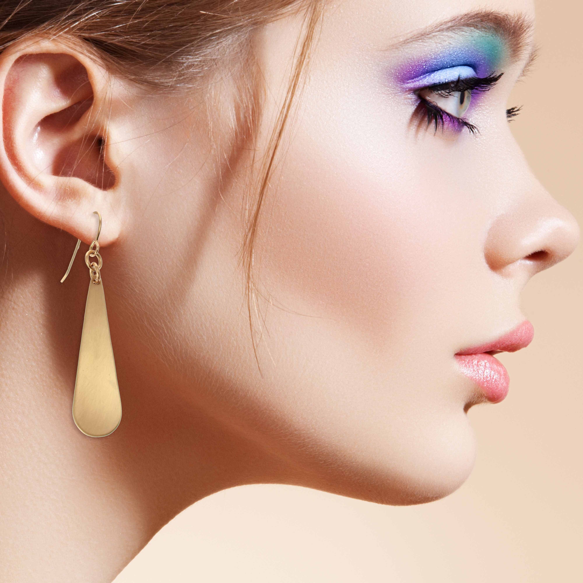 Elegant Woman Wearing Brushed Bronze Long Teardrop Earrings