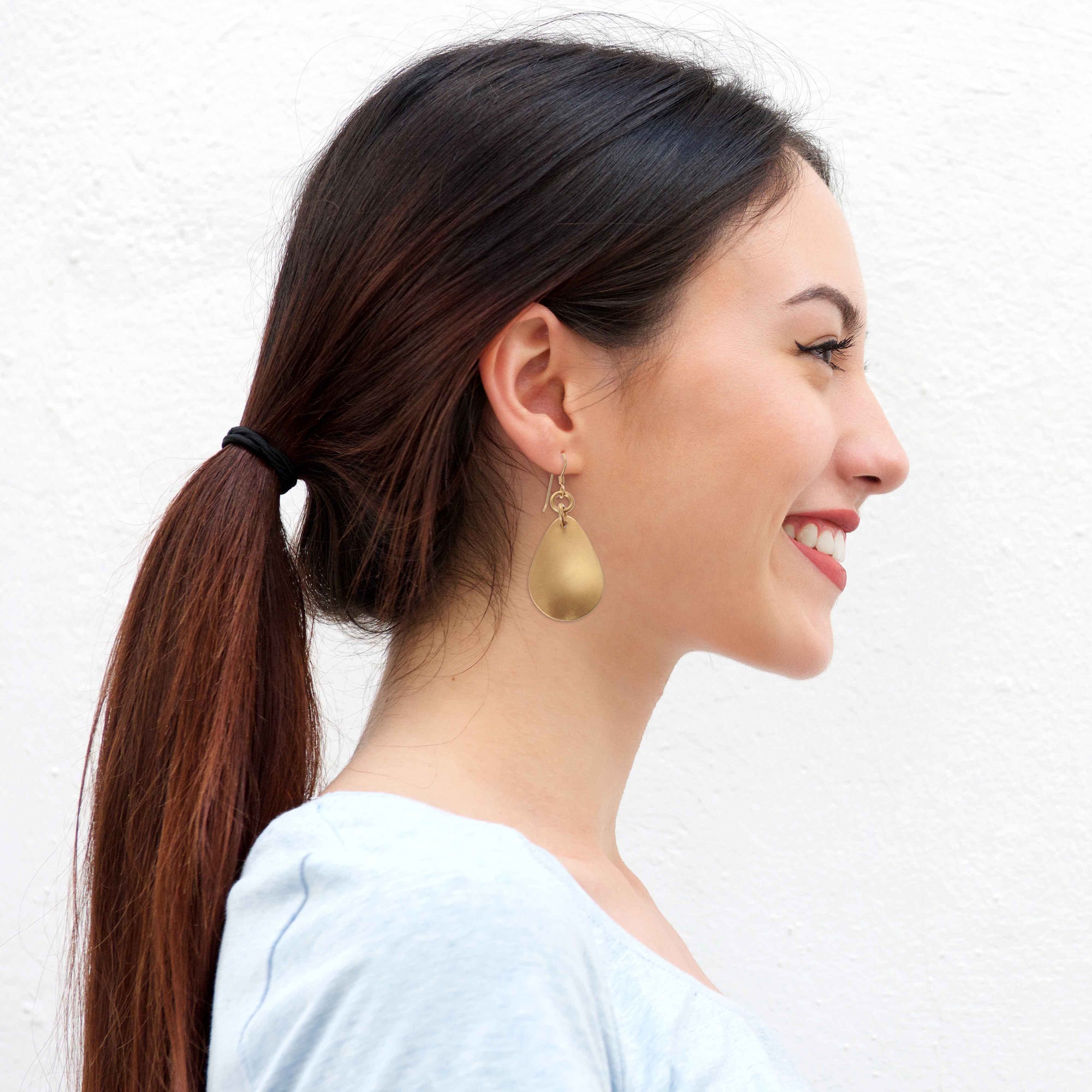 Fashionable Woman Wearing Brushed Bronze Medium Teardrop Earrings