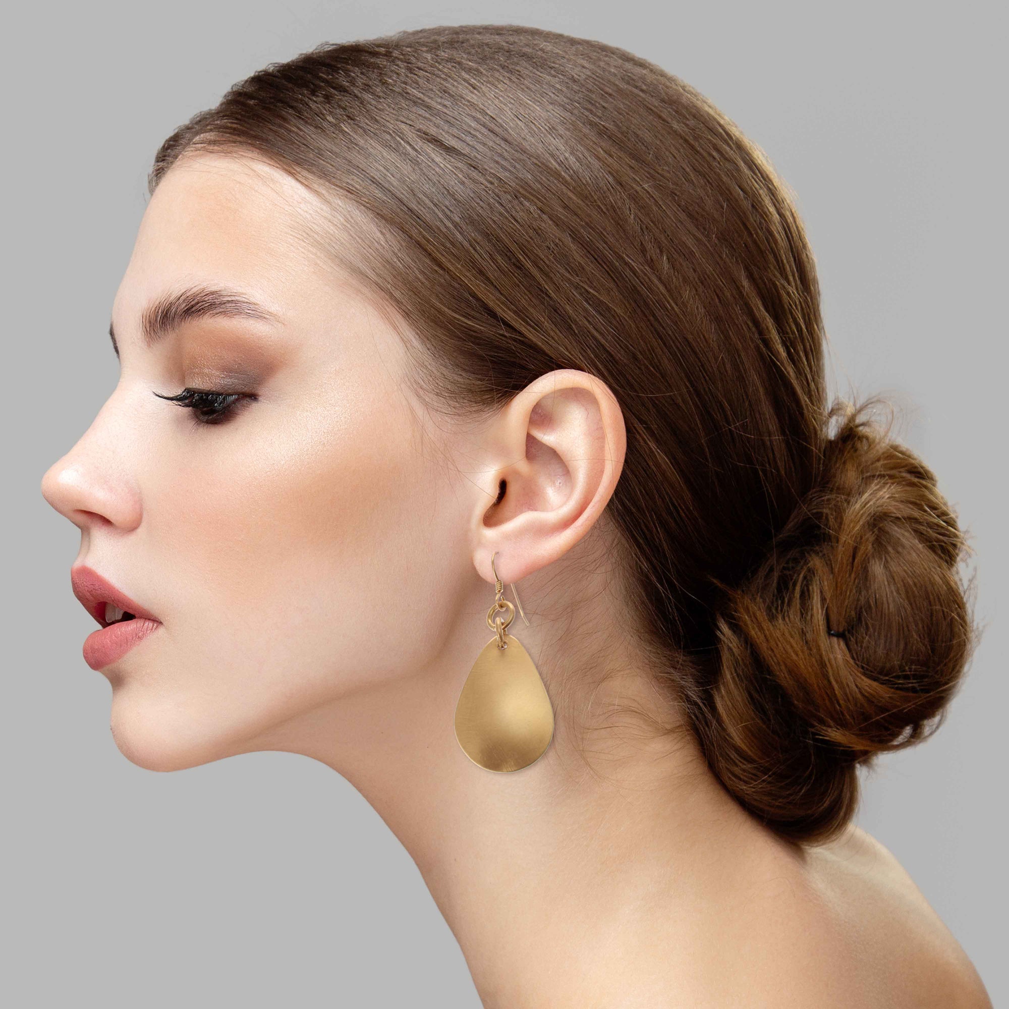 Elegant Woman Wearing Brushed Bronze Medium Teardrop Earrings