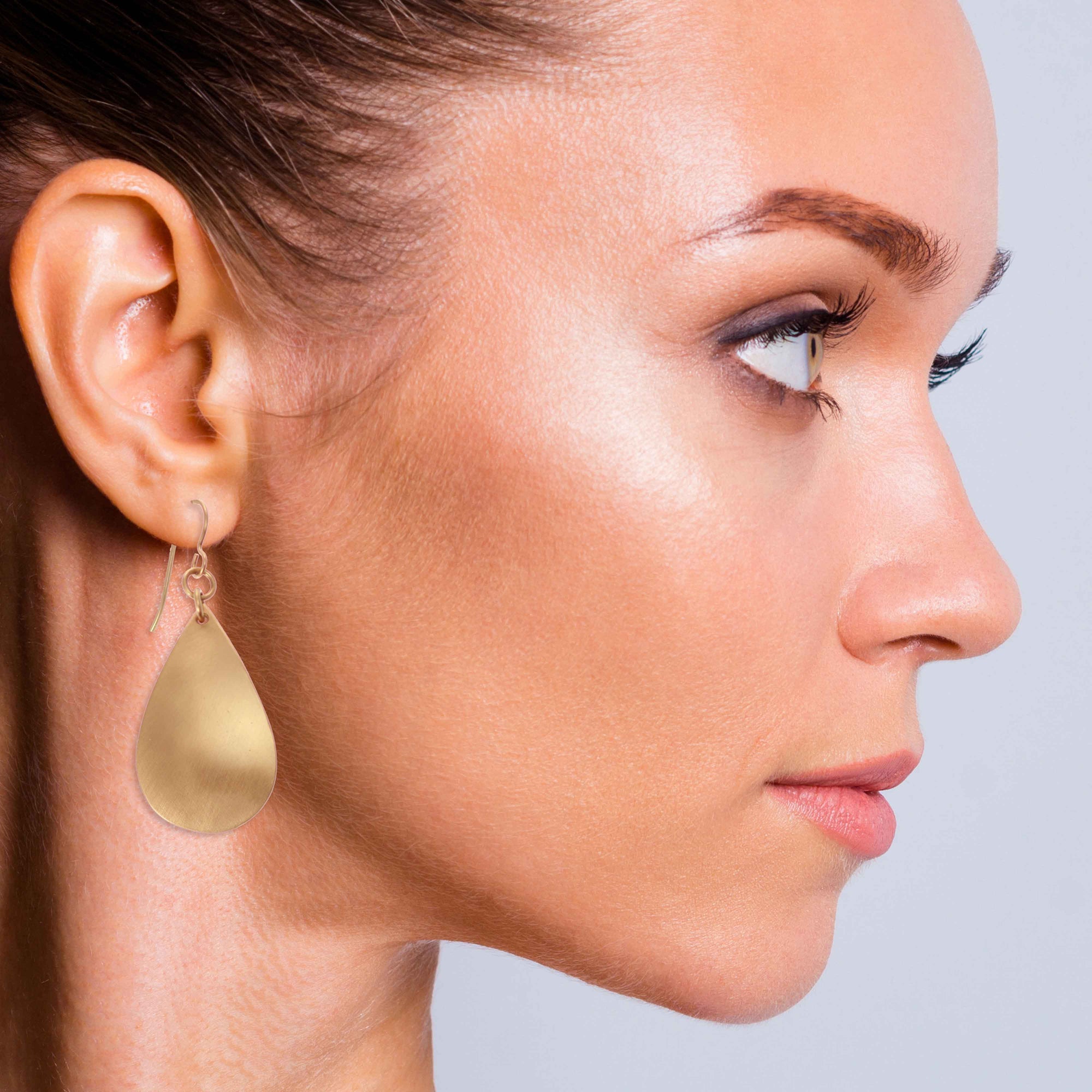 Elegant Woman Wearing Brushed Bronze Teardrop Earrings