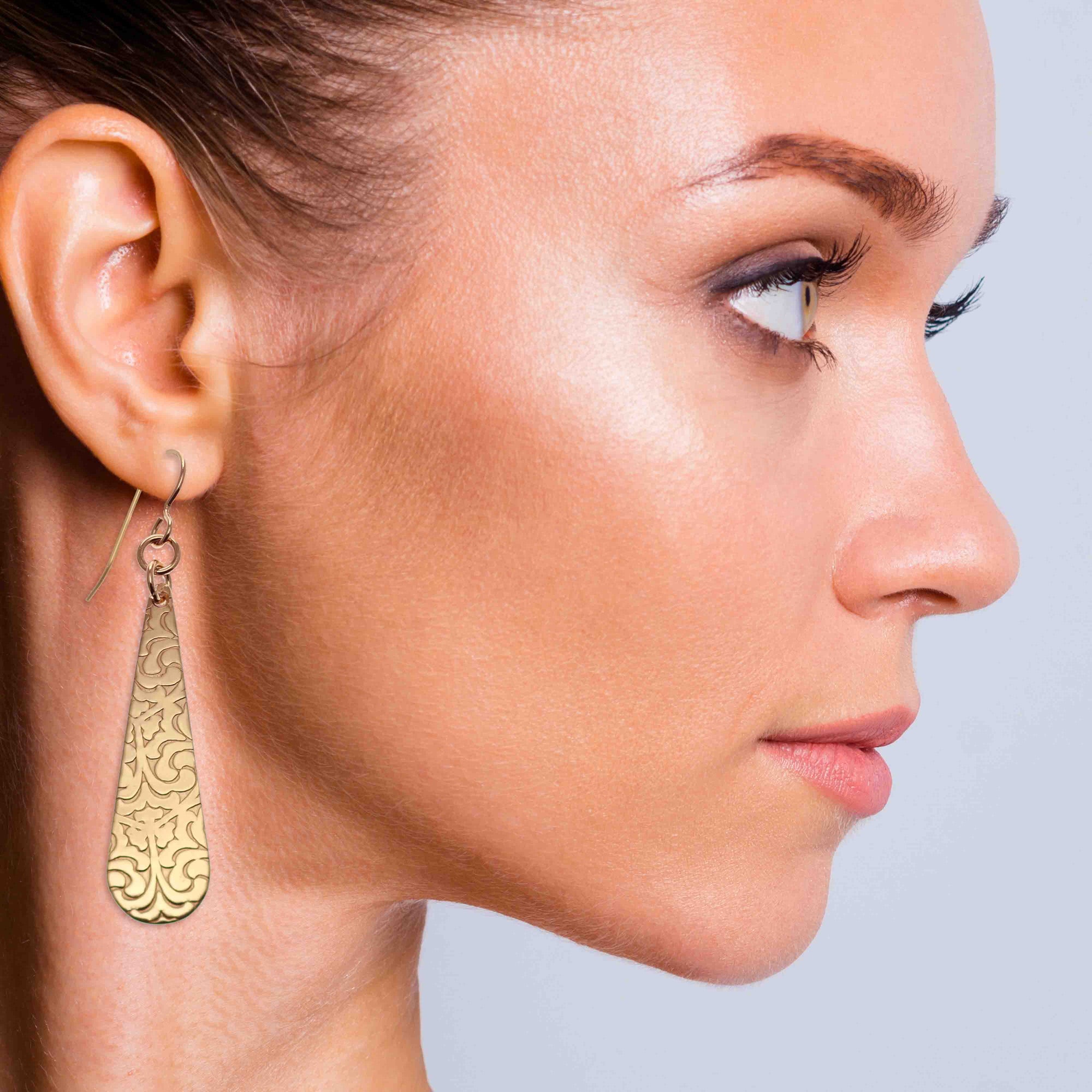 Chic Woman Wearing Damask Embossed Bronze Long Teardrop Earrings