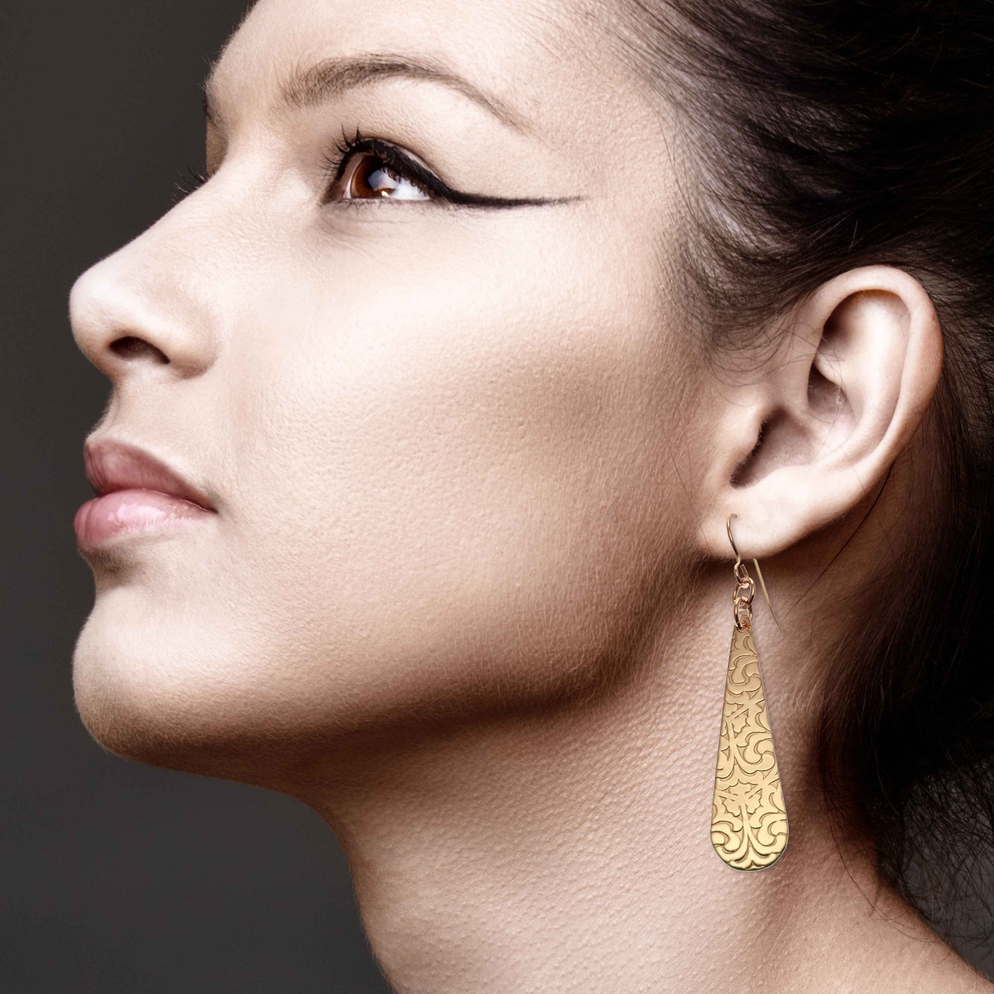 Elegant Woman Wearing Damask Embossed Bronze Long Teardrop Earrings