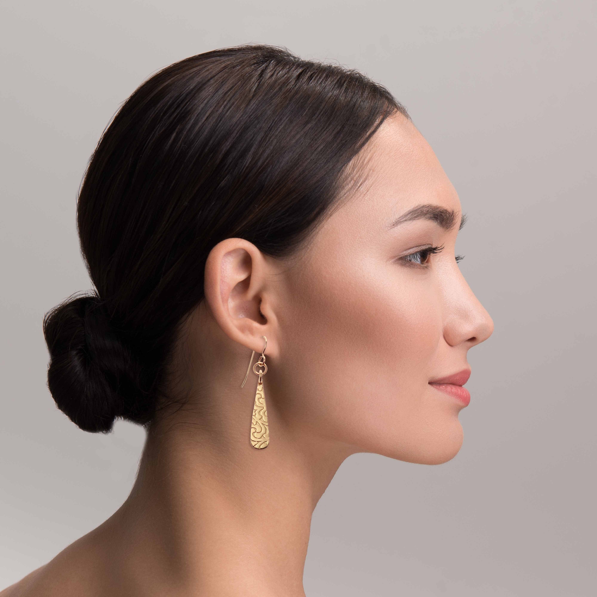 Chic Woman Wearing Damask Embossed Mini Bronze Teardrop Earrings