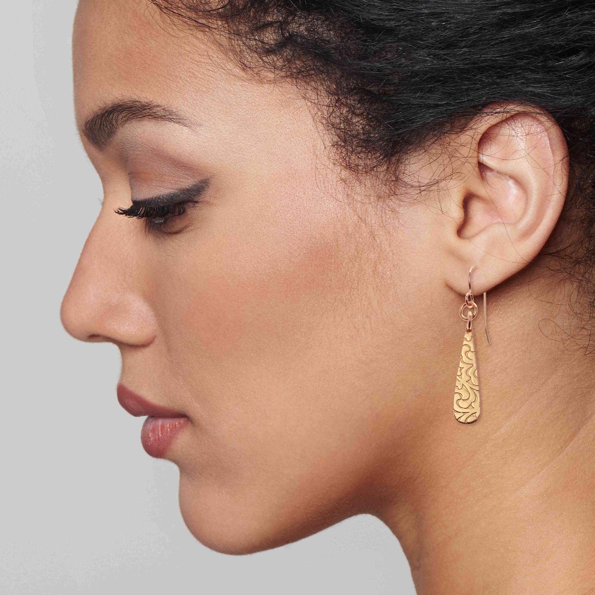 Elegant Woman Wearing Damask Embossed Mini Bronze Teardrop Earrings