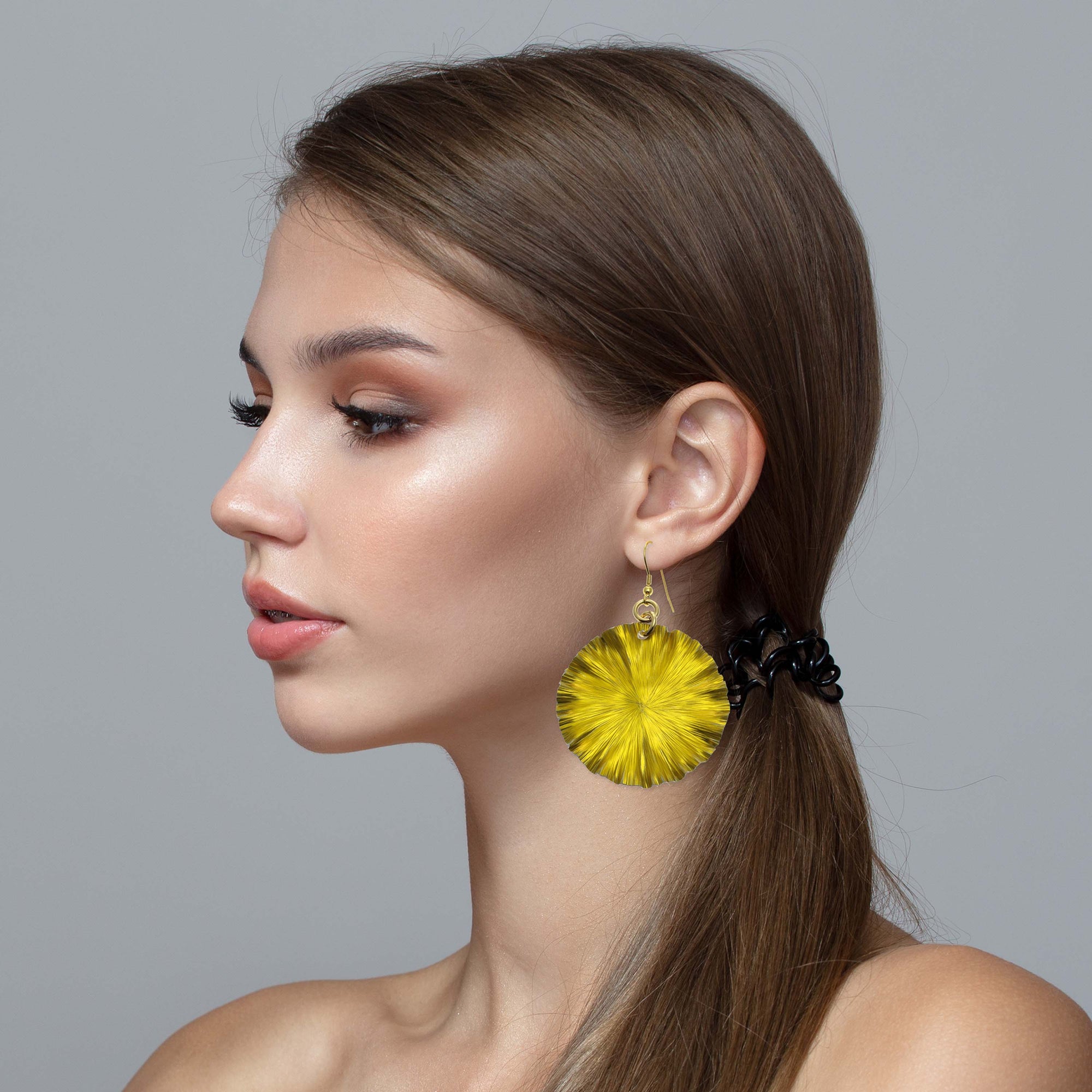 Stunning Woman Wearing Large Canary Yellow Lily Pad Anodized Aluminum Leaf Earrings