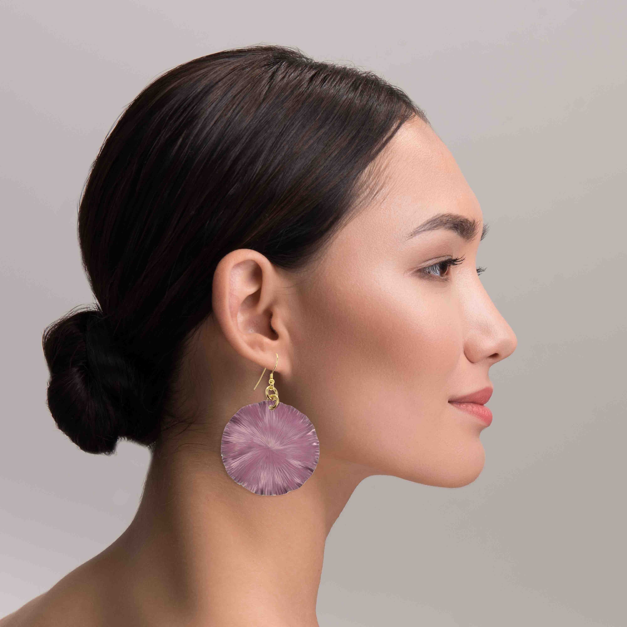 A Stunning Woman Wearing Large Mauve Anodized Aluminum Large Lily Earrings