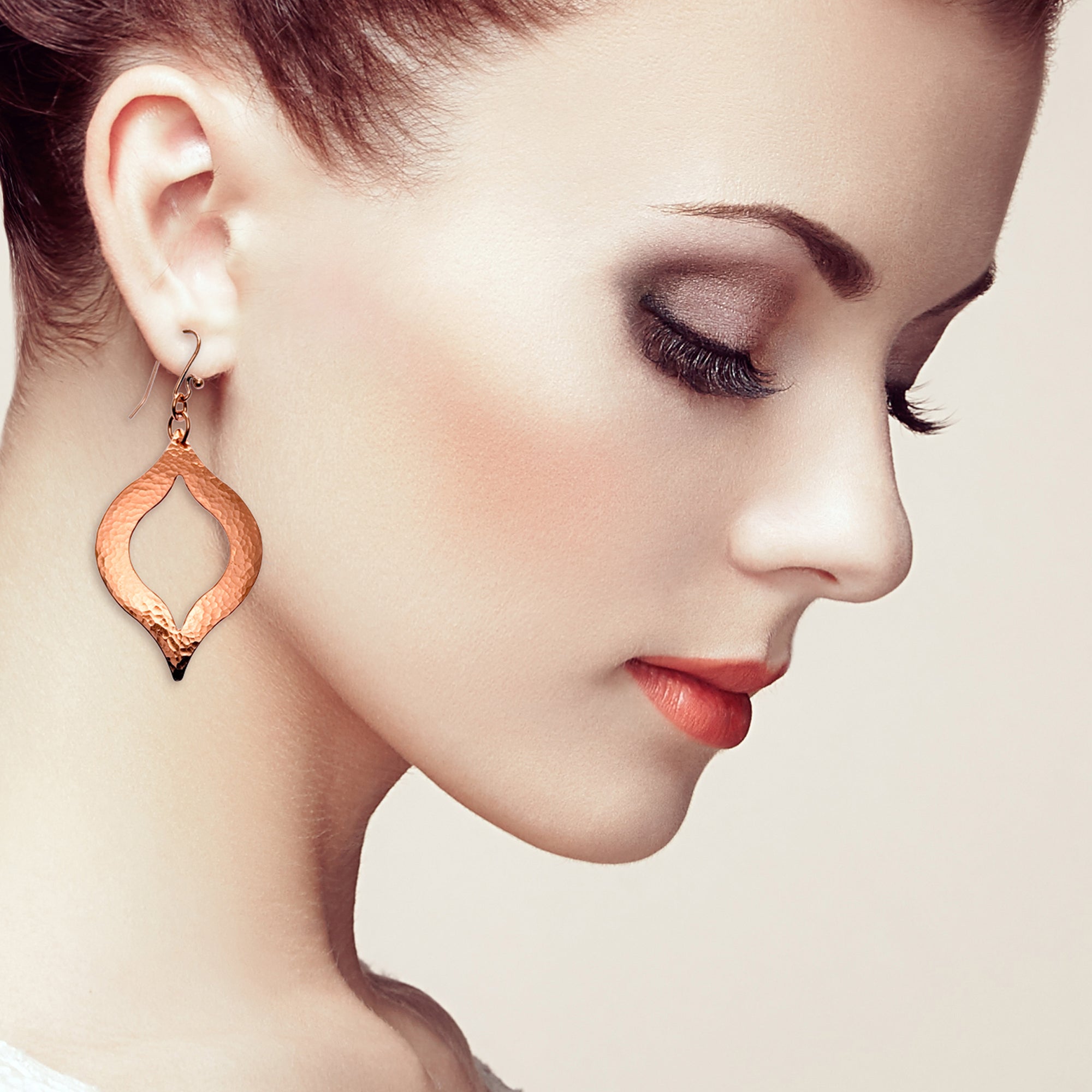 A Stylish Woman with Red hair Wearing Large Pierced Hammered Copper Marrakesh Earrings