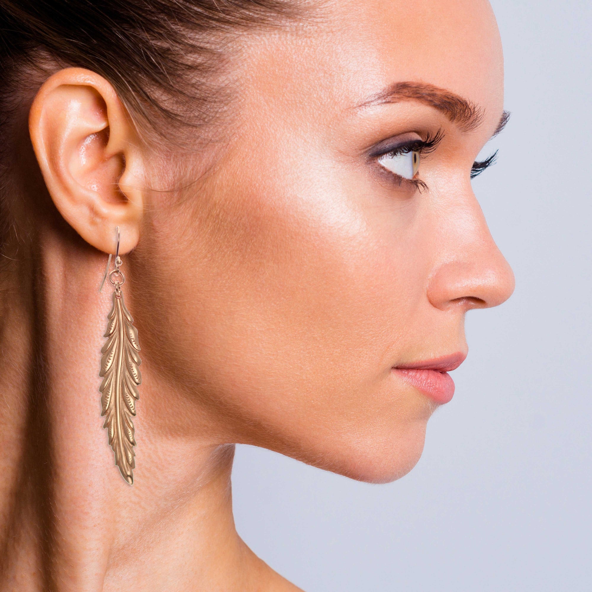 Glamorous Woman Wearing Long Feather Copper Drop Earrings