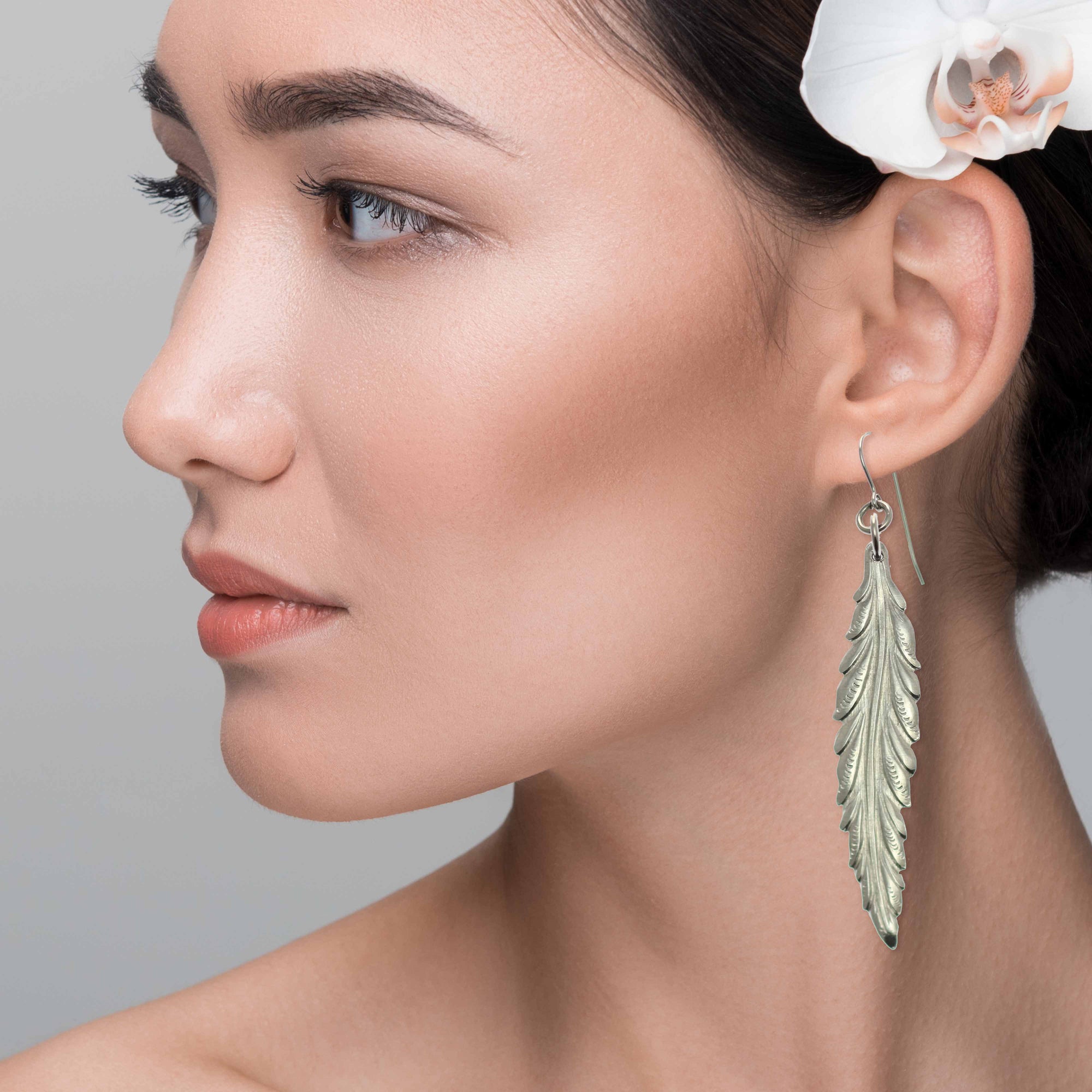 Stunning Woman Wearing Long Feather Aluminum Drop Earrings 