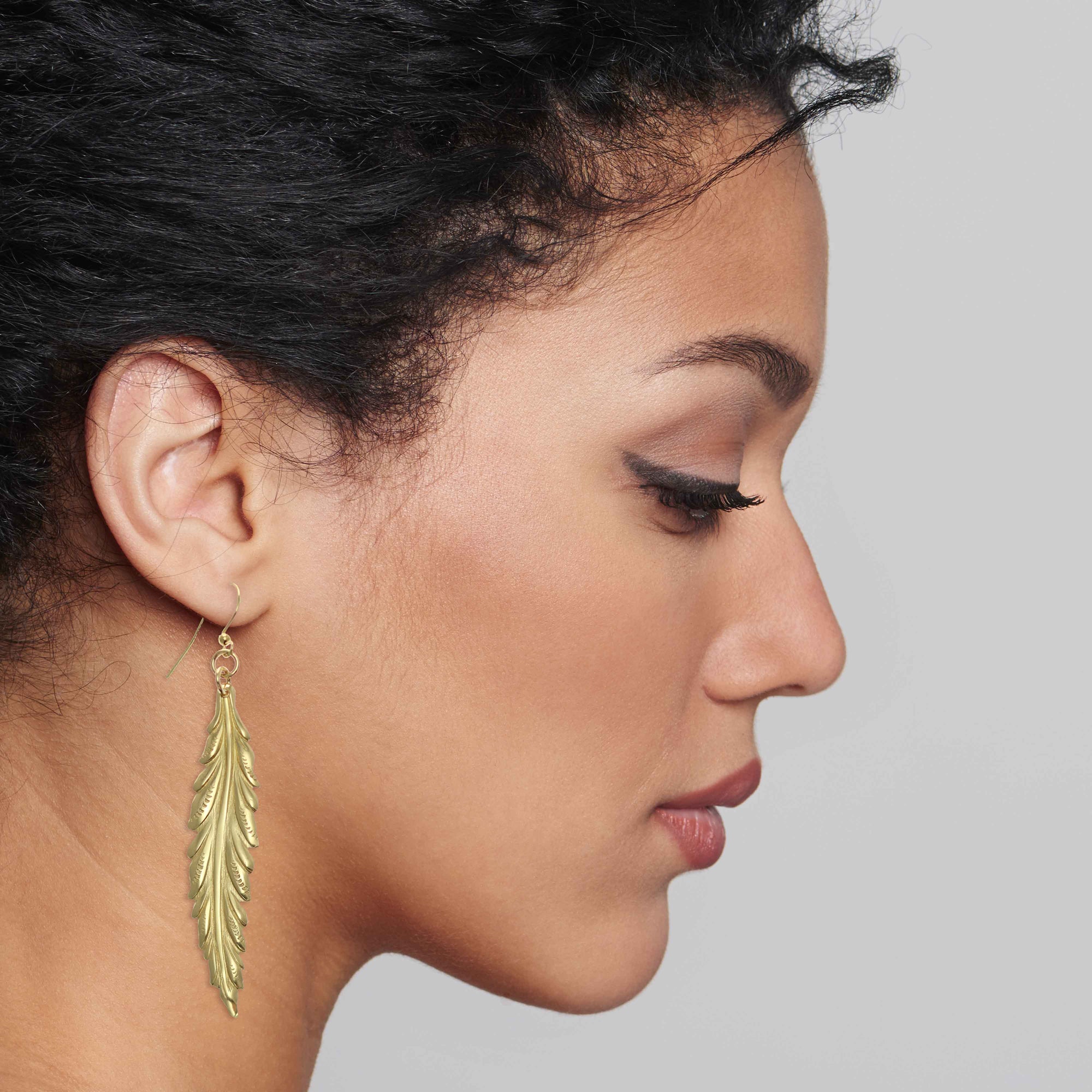 Stylish Woman Wearing Long Feather Brass Nu Gold Drop Earrings