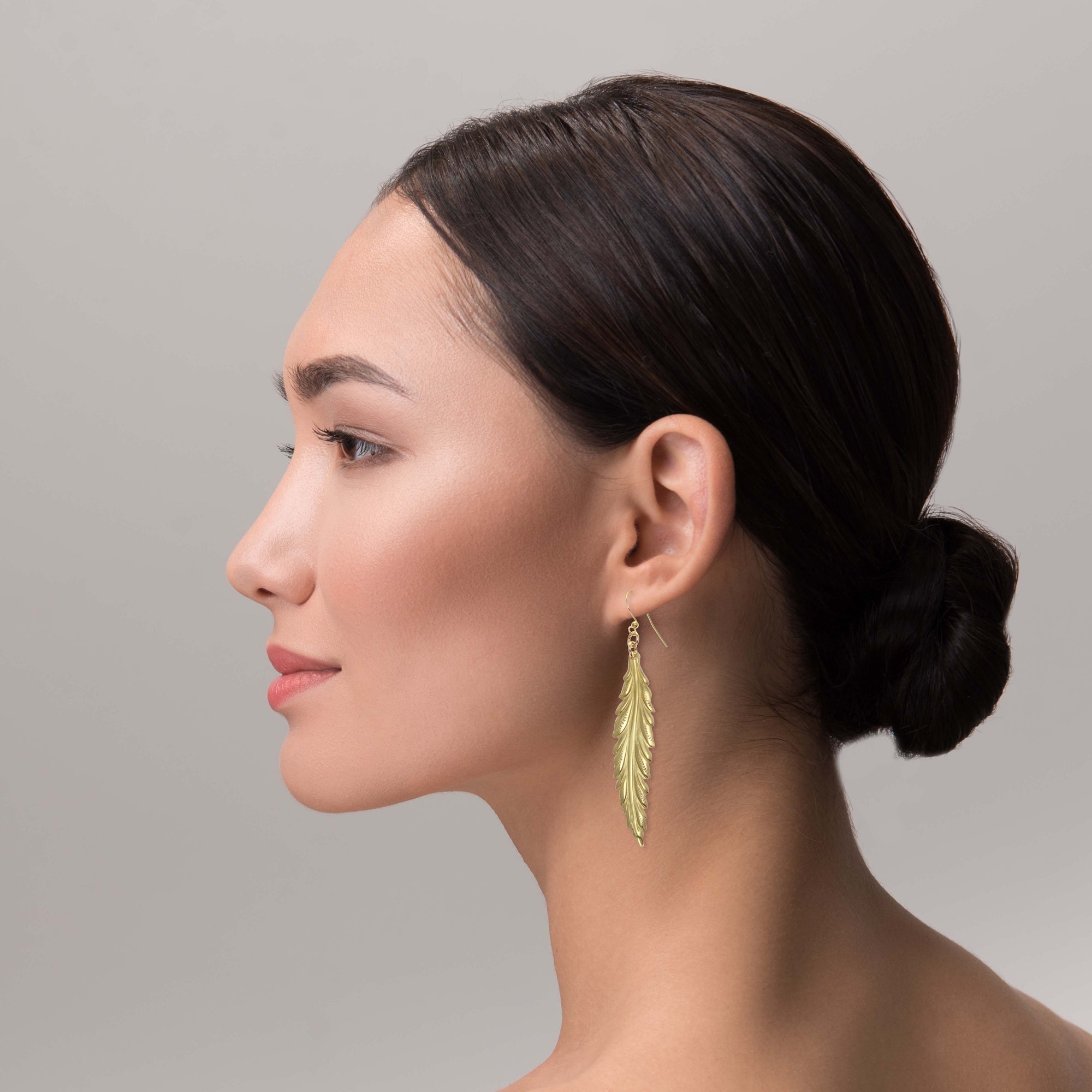 Elegant Woman Wearing Long Feather Brass Nu Gold Drop Earrings