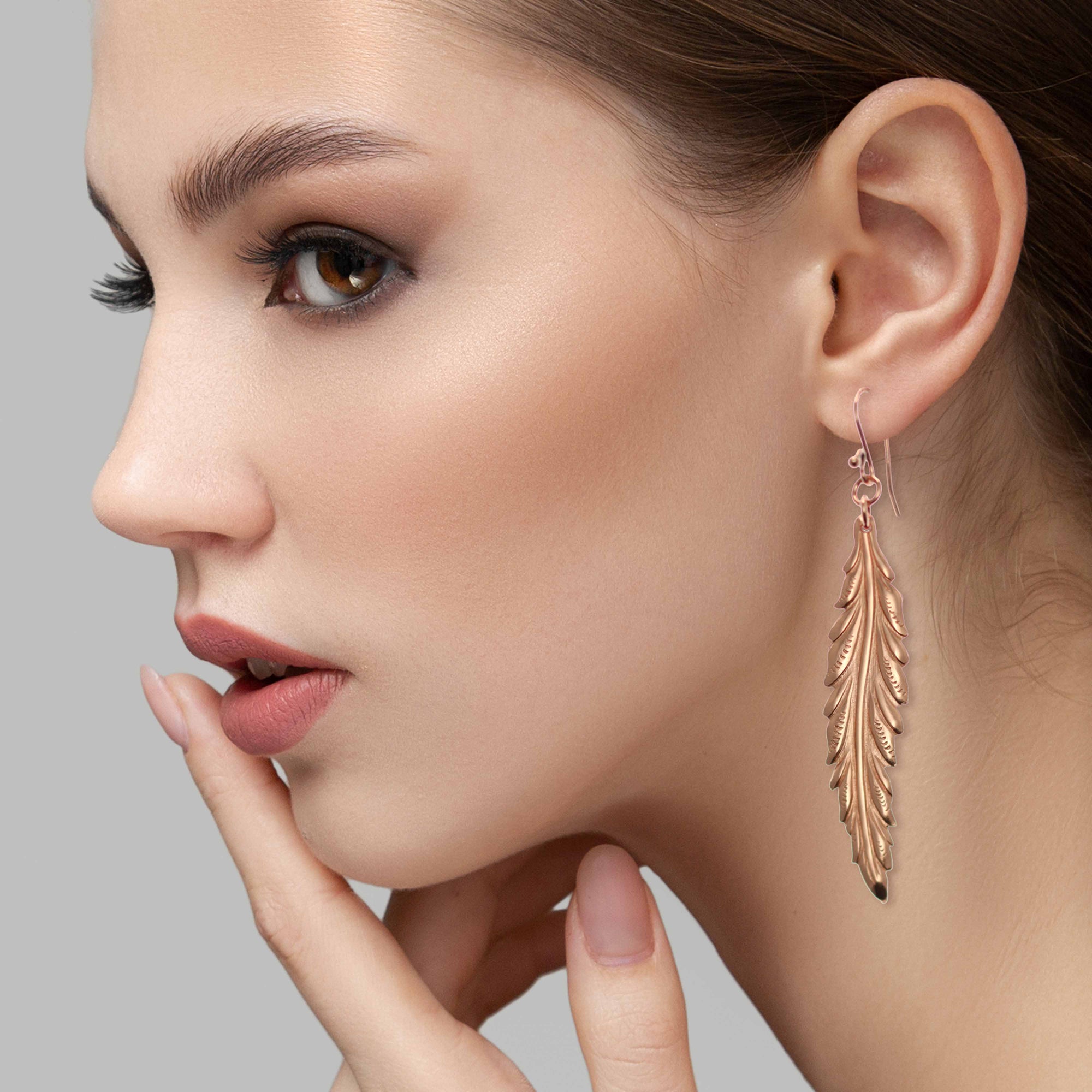 Elegant Woman Wearing Long Feather Copper Drop Earrings