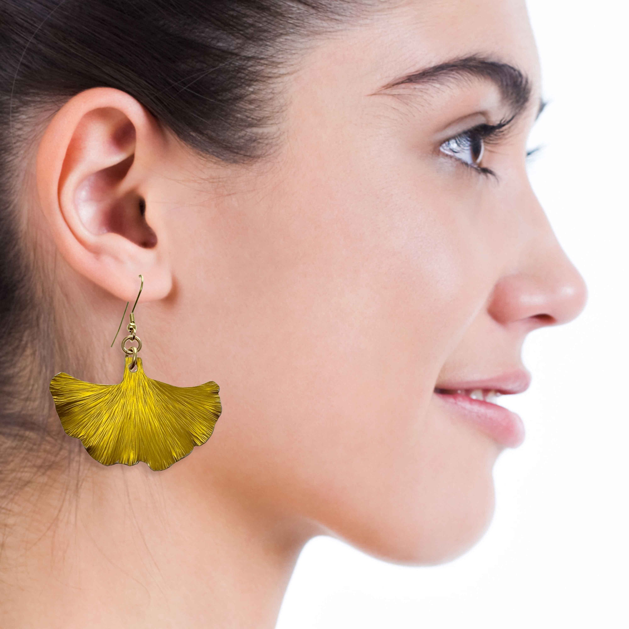 A Smiling Woman Wearing Medium Canary Yellow Anodized Ginkgo Leaf Earrings