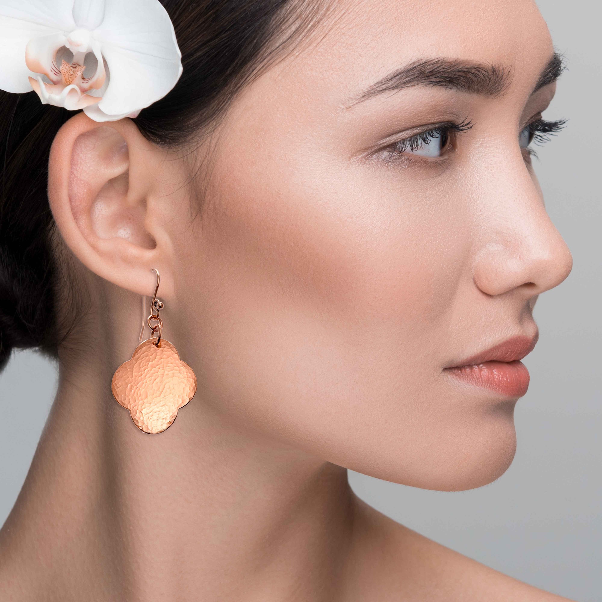 A Chic Woman Wearing Medium Hammered Copper Clover Drop Earrings