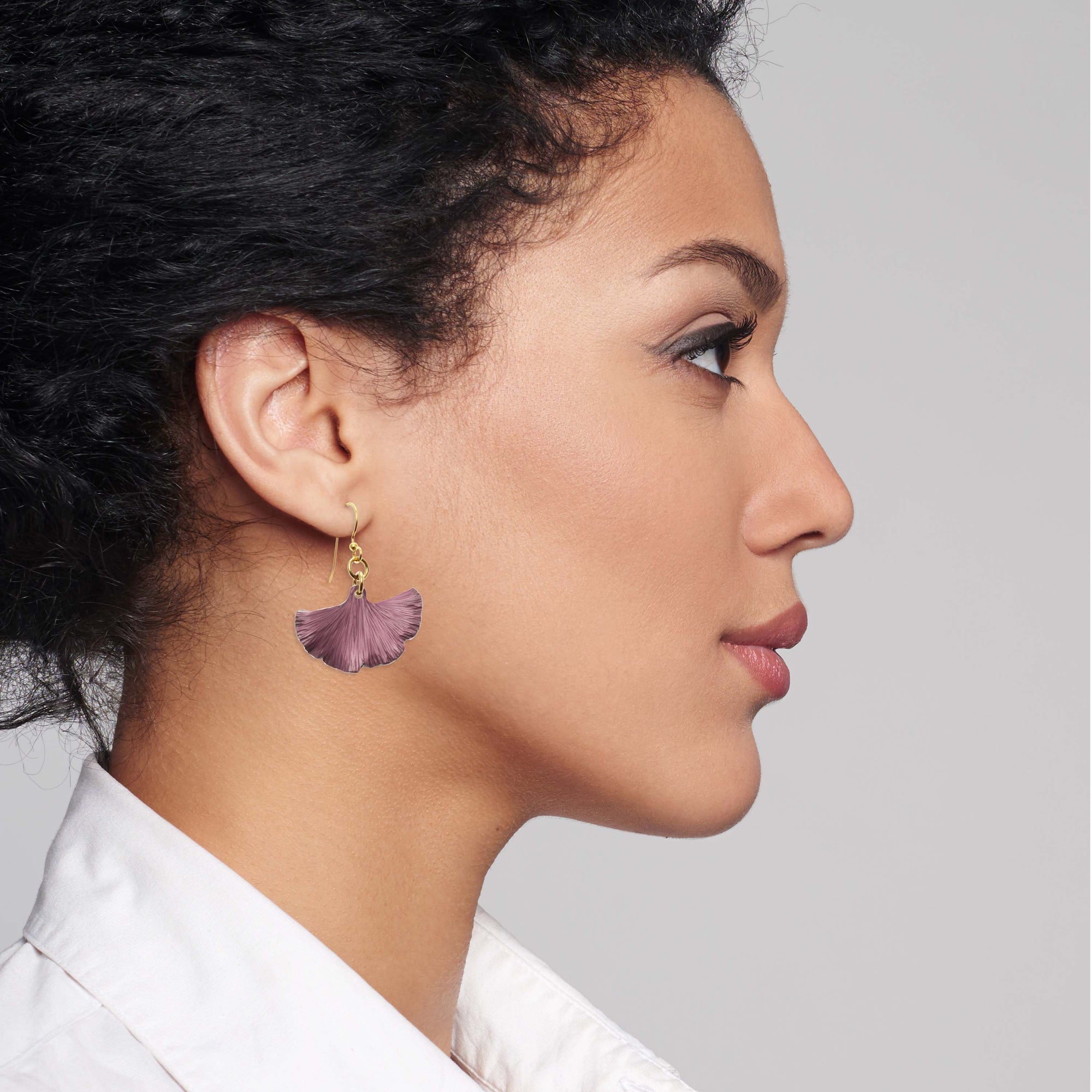 Chic Woman in White Blouse Wearing Small Mauve Ginkgo Leaf Anodized Aluminum Purple Earrings