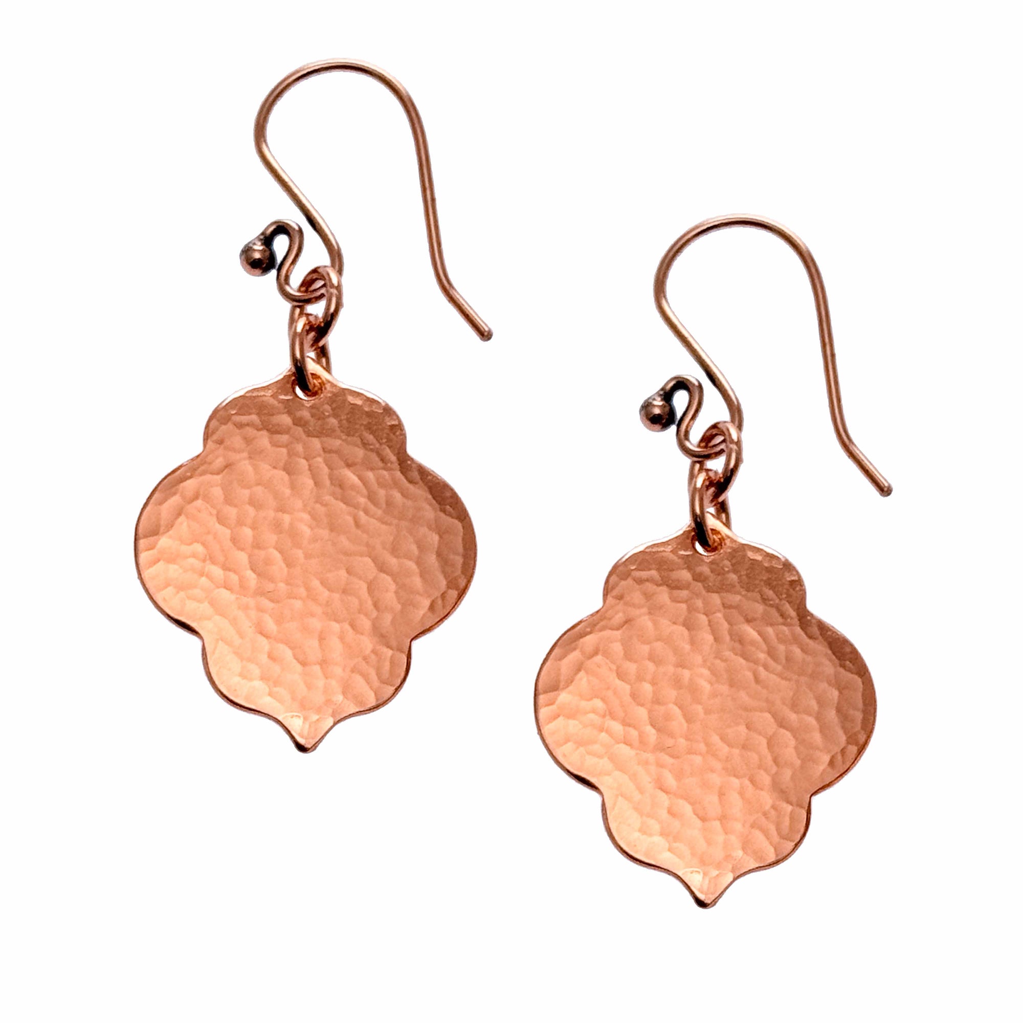 A Pair of Small Hammered Copper Quatrefoil Dangle Earrings on a White Background