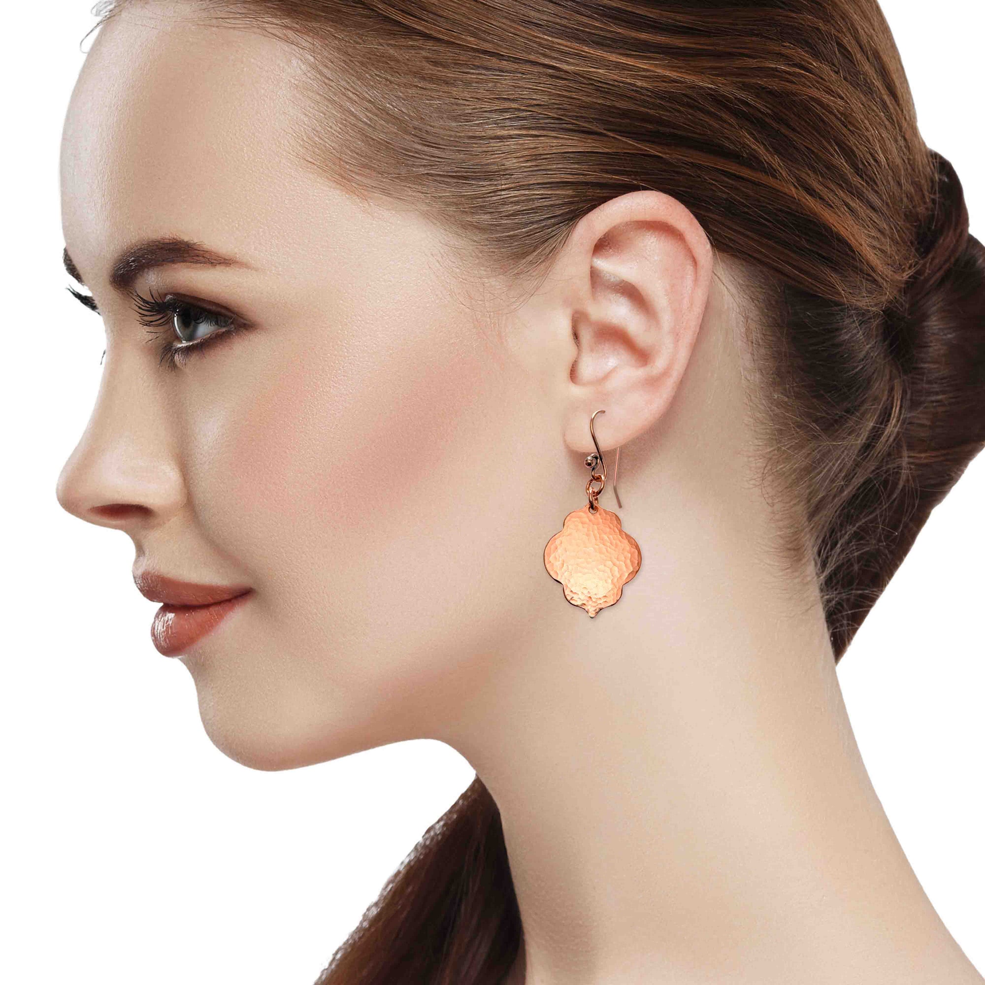 An Elegant Woman Wearing Small Hammered Copper Quatrefoil Dangle Earrings