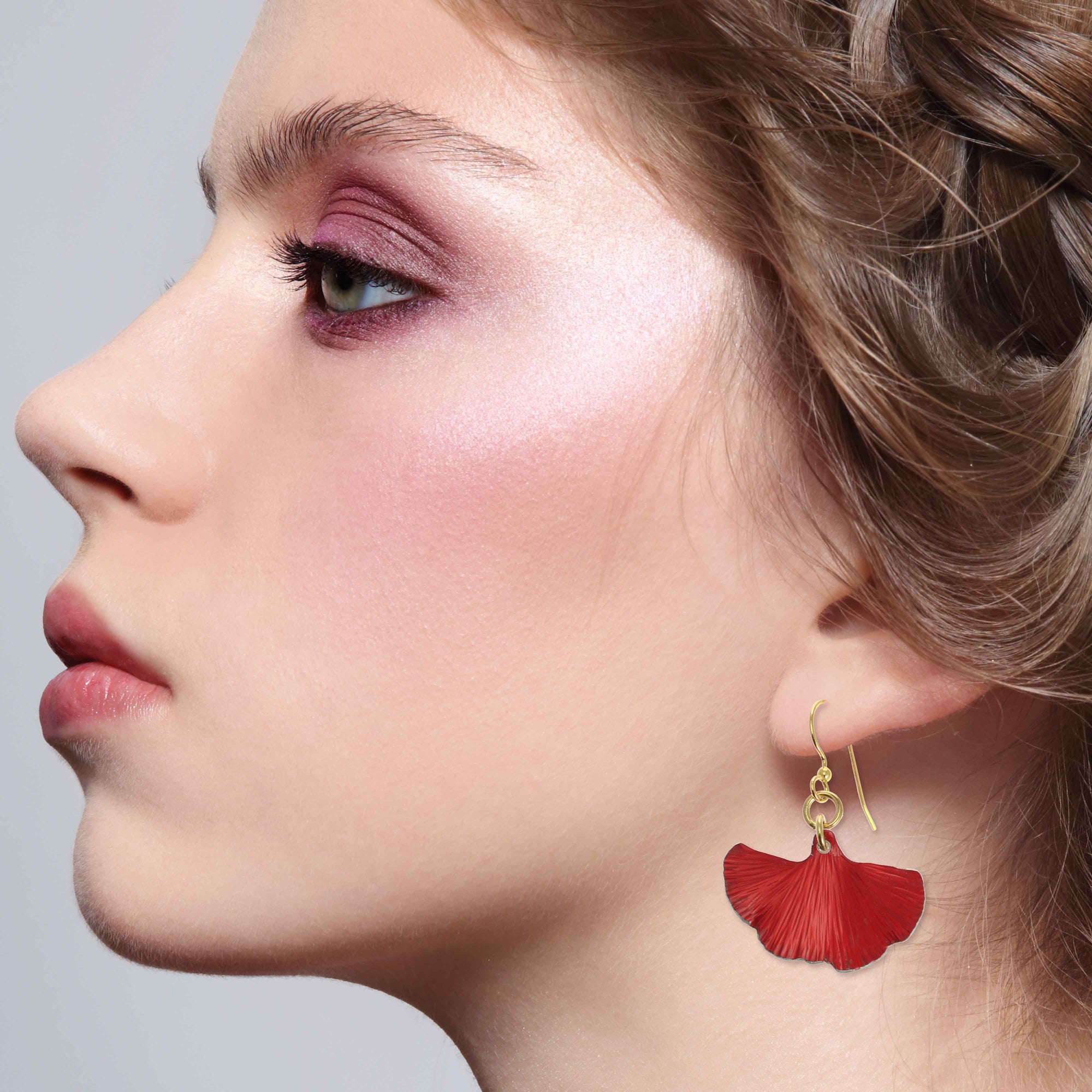 An Elegant Woman Wearing Small Red Ginkgo Leaf Anodized Aluminum Earrings 