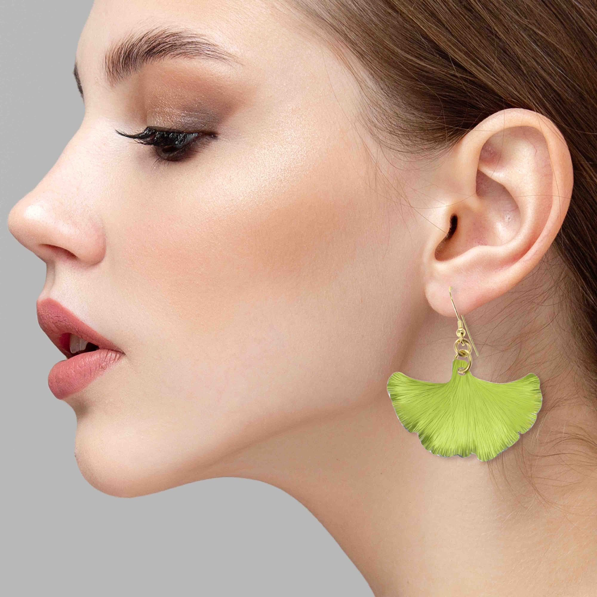 An Elegant Woman Wearing Medium Sour Candy Apple Anodized Aluminum Ginkgo Leaf Earrings