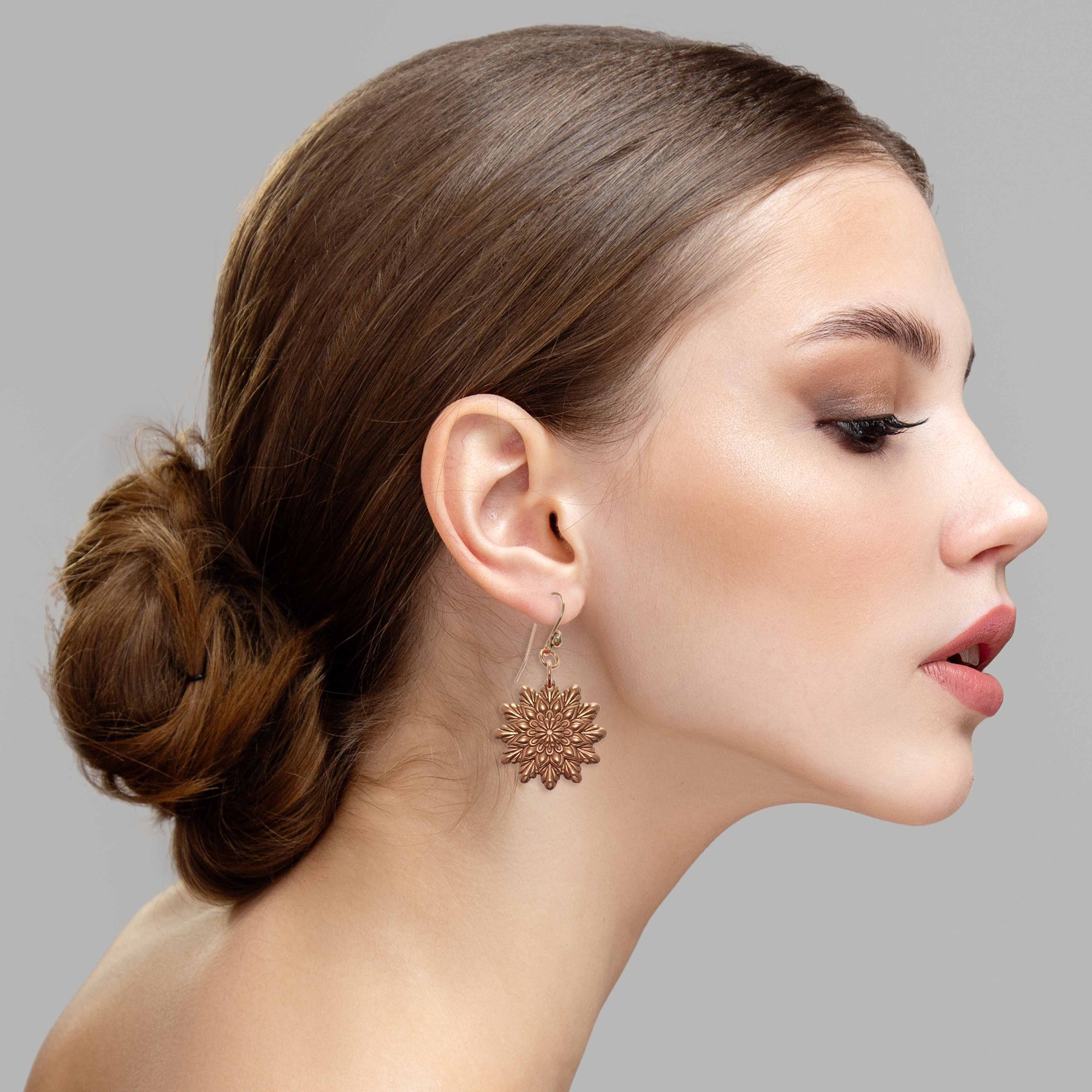 Elegant Woman Wearing Starburst Mandala Copper Earrings 